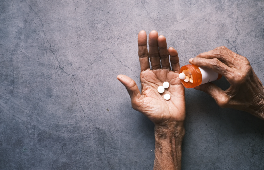 image of someone taking pills to illustrate AI cancer treatment